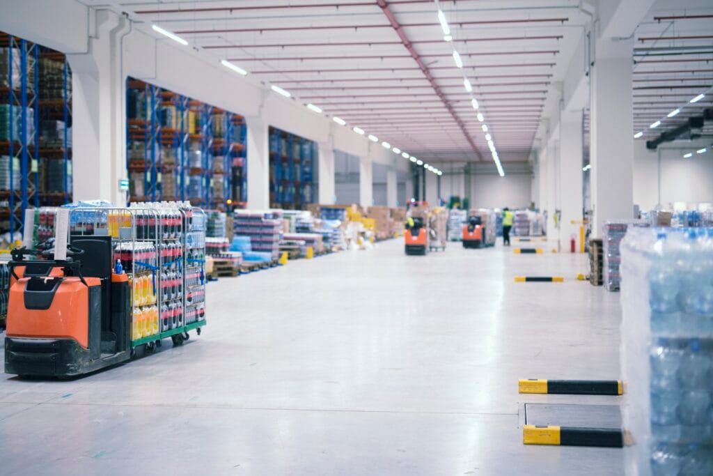 warehouse-industrial-building-interior-with-people-forklifts-handling-goods-storage-area